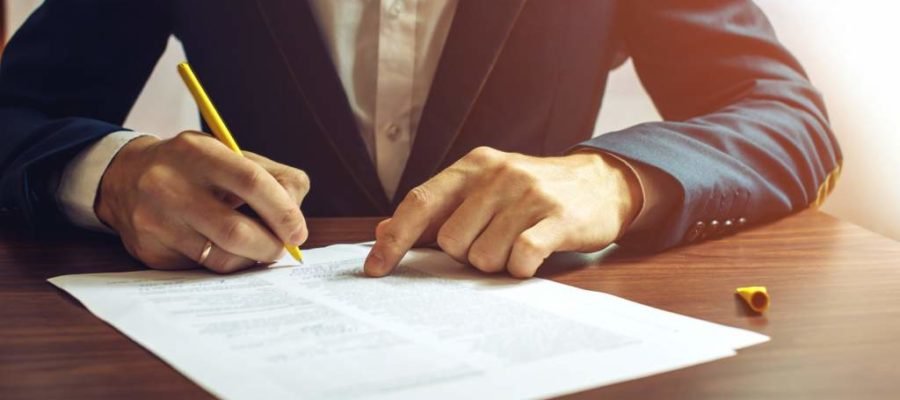 Man, signing, legal document, table, pen, suit, expansion, SafeStart press release, all around the world, world-wide, safety training, preventing injuries