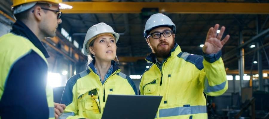 explanation, workplace communication, workers talking, plans, documents, working clothing, hard hat, smiling, workers, safety culture, safe working environment, factory hall, culture change, organisational change, sustainable safety culture, culture change across sites, human factors, SafeStart, SafeStart International, safety habits, workplace safety, occupational safety, improve safety culture, boost safety awareness, reduce human failure, reduce injuries, injury reduction, reduce accident rates, improve company figures, prevent critical errors, implement a positive culture change at your company, promote employee engagement, boost employee commitment, 24/7 safety, safety round the clock, being safe 24/7, safe behavioural patterns, learn safe behaviour, acquire universal safety skills, safety skill for families, safety skills for children, safety skills for everyone, safety training for employees, safety for the whole company, safety training for kids, improve operational efficiency, improve quality, safety-related habits, safety-related behaviour, risk patterns, ensure high performance, critical states, critical decisions, critical errors, how injuries occur, how to prevent injuries, how to prevent accidents